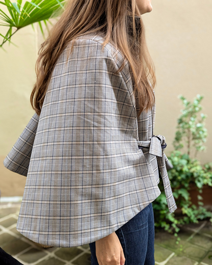 Cape pour femme réversible et imperméable, vue manche côté carreaux tartan, élégante et pratique pour toutes saisons